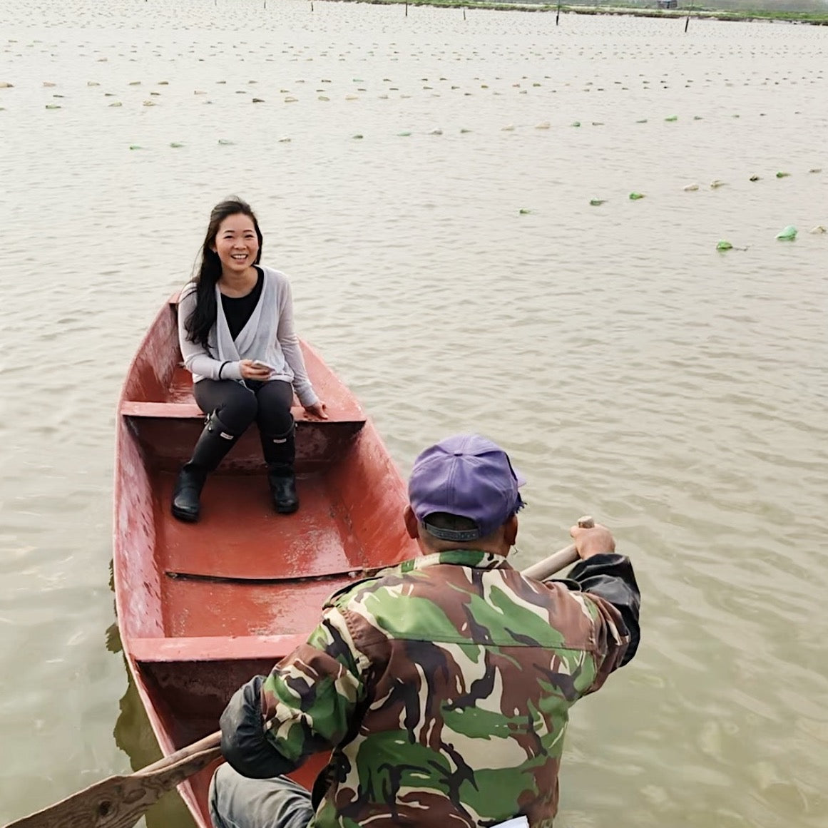 Founder of La Grotta sitting on a boat visiting the small family run pearl farms in China