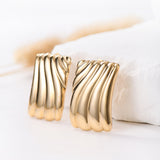 Caelynn Gold Wave Statement Earrings