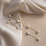 Long dangling freshwater pearl and solid gold earring