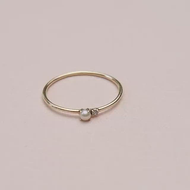 Video of dainty pearl and diamond solid gold ring