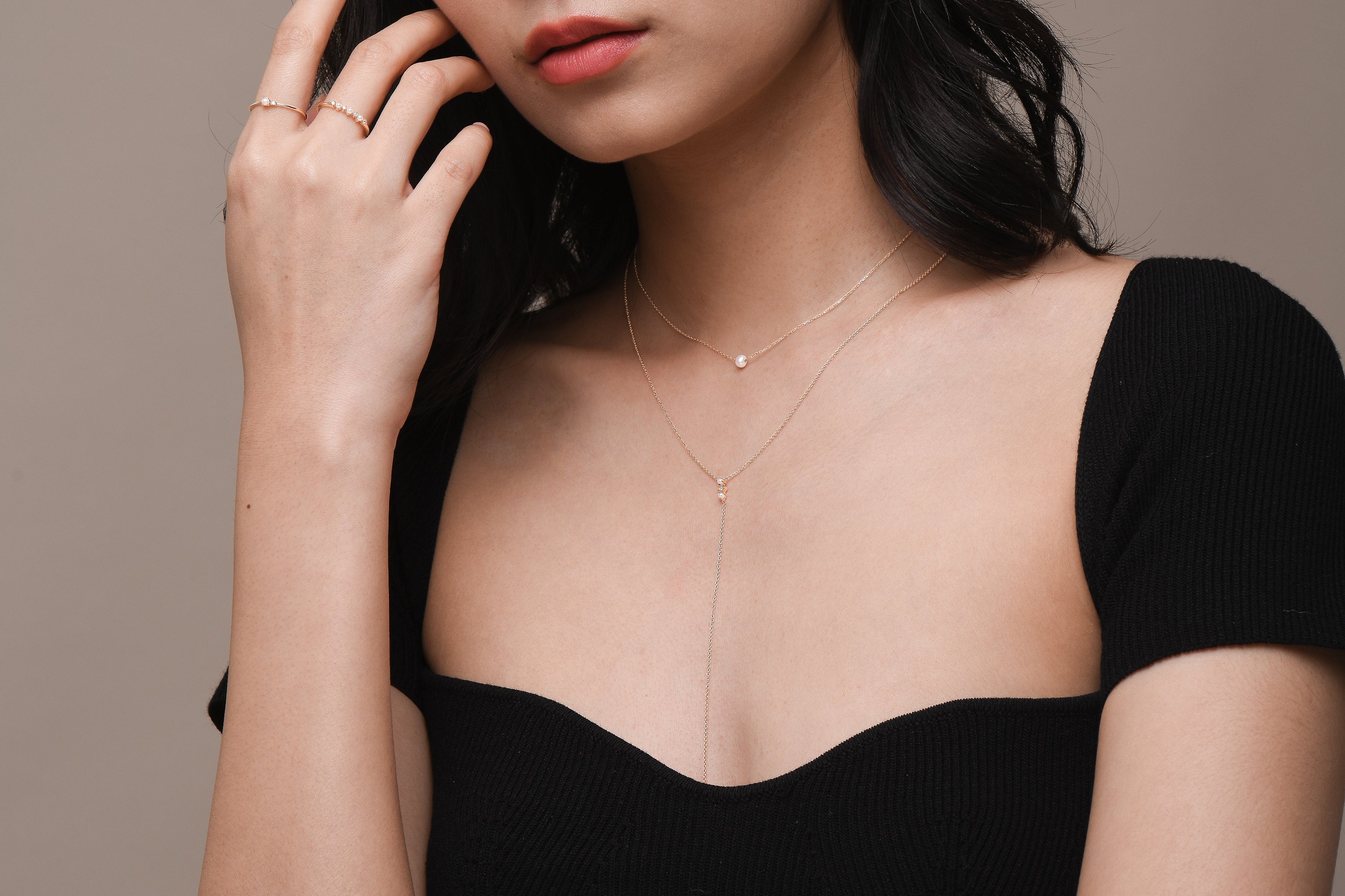 Model wearing dainty freshwater pearl and solid gold jewellery