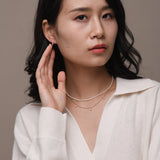 Model wearing mini freshwater pearl and solid gold jewellery