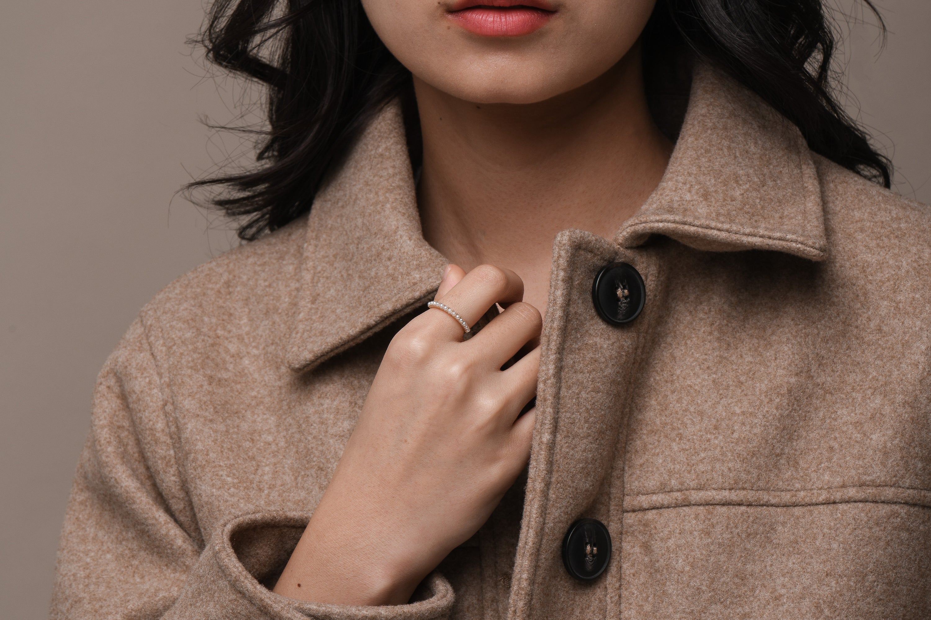 Model wearing mini pearl and solid gold ring