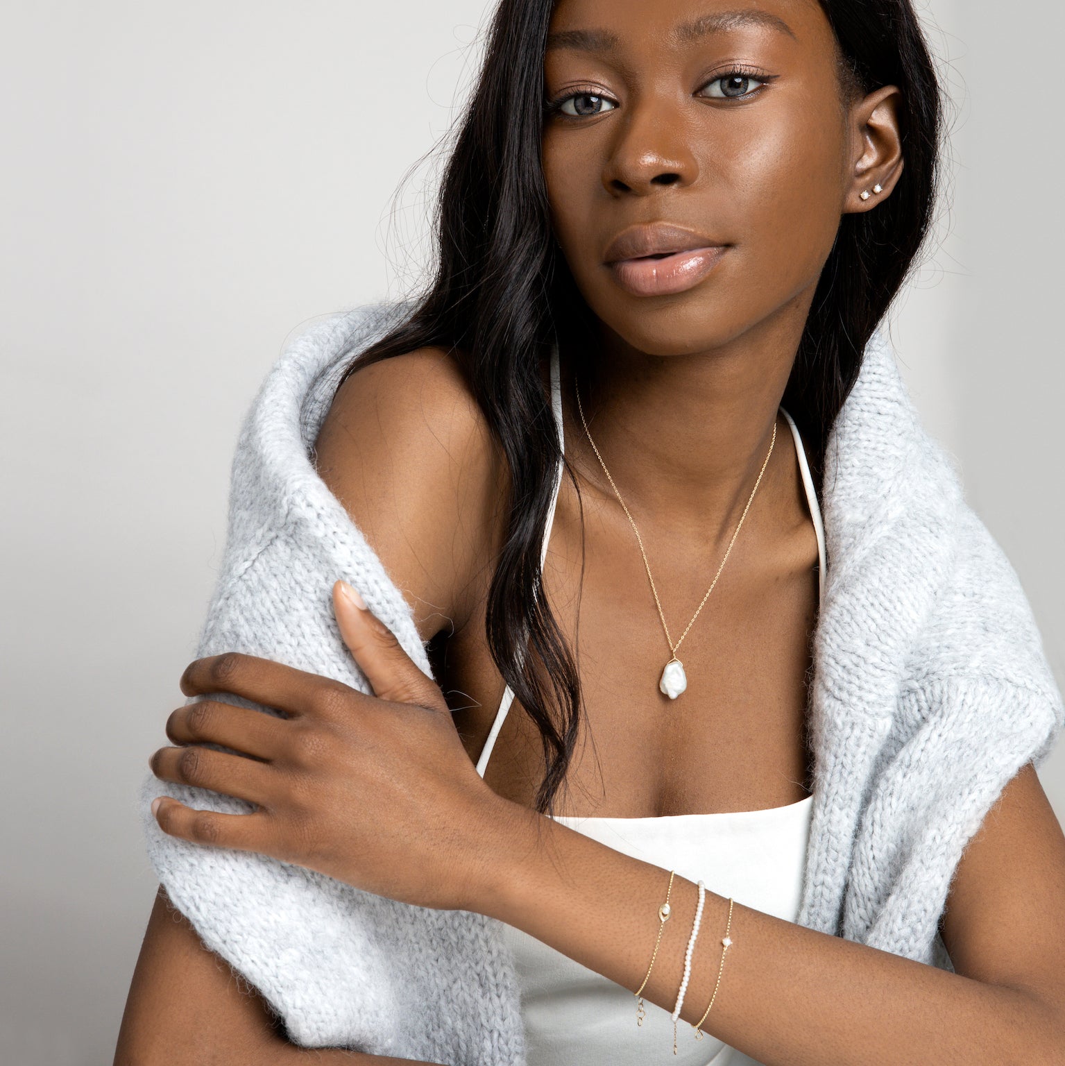 Model wearing freshwater pearl and solid gold jewellery
