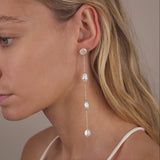 Video of model wearing long dangling freshwater pearl and solid gold earring