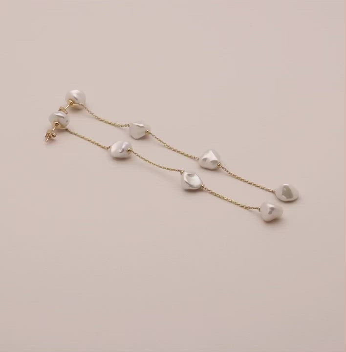 Video of long dangling freshwater pearl and solid gold earring